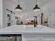 Bright kitchen island with a modern sink, stainless steel dishwasher and barn door at 12641 S 39Th Pl, Phoenix, AZ 85044