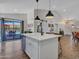 Modern kitchen island with seating, white cabinets, and stainless steel dishwasher at 12641 S 39Th Pl, Phoenix, AZ 85044