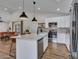 Spacious kitchen featuring stainless appliances, quartz counters, and open to the dining area at 12641 S 39Th Pl, Phoenix, AZ 85044