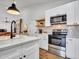 Modern kitchen featuring white cabinets, stainless steel appliances, and hardwood floors at 12641 S 39Th Pl, Phoenix, AZ 85044