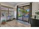 Bright living room with hardwood floors, sliding glass doors to a patio, and modern decor at 12641 S 39Th Pl, Phoenix, AZ 85044