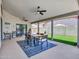 Covered patio featuring a dining table, ceiling fans, and views of the backyard, ideal for outdoor entertaining and relaxation at 12641 S 39Th Pl, Phoenix, AZ 85044