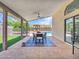 Covered patio with dining area and views of the pool, string lights, and outdoor seating, ideal for relaxation and entertainment at 12641 S 39Th Pl, Phoenix, AZ 85044