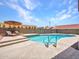 Inviting pool area with sun loungers and clear blue water, surrounded by lush greenery and block wall fencing at 12641 S 39Th Pl, Phoenix, AZ 85044