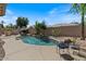 Landscaped backyard with a pool, rock accents, a built in bbq and lush trees at 1321 E Monteleone St, San Tan Valley, AZ 85140