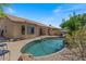Inviting backyard pool with stone accents and lounging area, perfect for relaxing and entertaining at 1321 E Monteleone St, San Tan Valley, AZ 85140