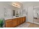 Well-lit bathroom featuring double sinks, generous counter space, and tile flooring at 1321 E Monteleone St, San Tan Valley, AZ 85140