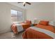 Well-lit bedroom featuring carpet, ceiling fan, and twin beds perfect for children or guests at 1321 E Monteleone St, San Tan Valley, AZ 85140