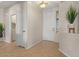 Well-lit entryway with neutral tones, tile flooring, and access to a laundry room and other areas of the house at 1321 E Monteleone St, San Tan Valley, AZ 85140