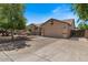 Inviting single-story home with desert landscaping and a spacious driveway leading to an attached two-car garage at 1321 E Monteleone St, San Tan Valley, AZ 85140