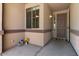 Charming front porch with decorative lanterns, potted flowers, and a welcoming door mat, creating curb appeal at 1321 E Monteleone St, San Tan Valley, AZ 85140