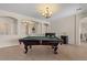 Entertaining game room with pool table under a chandelier at 1321 E Monteleone St, San Tan Valley, AZ 85140