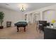 Well-lit game room area with a pool table and bar seating at 1321 E Monteleone St, San Tan Valley, AZ 85140