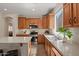 Bright kitchen featuring stainless appliances, wood cabinets, and white countertops at 1321 E Monteleone St, San Tan Valley, AZ 85140