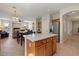 Open kitchen and dining area layout with stainless steel fridge at 1321 E Monteleone St, San Tan Valley, AZ 85140