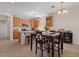 Open concept kitchen and dining area with island and wood cabinetry at 1321 E Monteleone St, San Tan Valley, AZ 85140
