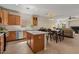 Open concept kitchen with stainless appliances, a kitchen island, and a dining area adjacent to a comfortable living space at 1321 E Monteleone St, San Tan Valley, AZ 85140