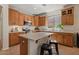 This kitchen includes an island, stainless appliances, and ample wood cabinetry at 1321 E Monteleone St, San Tan Valley, AZ 85140