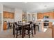 Open kitchen and dining area with an island, wood cabinets, and appliances at 1321 E Monteleone St, San Tan Valley, AZ 85140