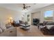 Comfortable living room with large windows and ceiling fan at 1321 E Monteleone St, San Tan Valley, AZ 85140