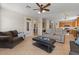 Spacious living room showcasing tile floors and an open layout into the kitchen and dining area at 1321 E Monteleone St, San Tan Valley, AZ 85140