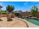 Inviting backyard oasis with a sparkling pool, built-in bar, and comfortable lounge chairs at 1321 E Monteleone St, San Tan Valley, AZ 85140