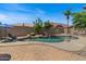 Lush backyard featuring a sparkling pool, rock features, and a well-manicured landscape at 1321 E Monteleone St, San Tan Valley, AZ 85140