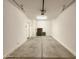 Clean, empty garage with a painted floor and an entrance door at 1415 E Chipman Rd, Phoenix, AZ 85040