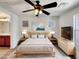Cozy main bedroom with a ceiling fan, stylish decor, and natural light at 1415 E Chipman Rd, Phoenix, AZ 85040