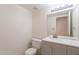 Bright bathroom featuring gray vanity, ample lighting, and classic fixtures at 1446 E Grovers Ave # 13, Phoenix, AZ 85022