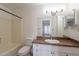 Bathroom with granite countertop, white vanity, and white bathtub and toilet at 1446 E Grovers Ave # 13, Phoenix, AZ 85022