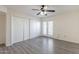 A spacious bedroom features wood floors, ceiling fan, closet, and door to outside at 1446 E Grovers Ave # 13, Phoenix, AZ 85022