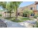 Attractive townhomes with manicured lawns, mature trees, and sidewalk, featuring gated pool area at 1446 E Grovers Ave # 13, Phoenix, AZ 85022