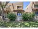 Charming townhome with well-manicured lawn, mature trees, and welcoming sign with light blue door and window trim at 1446 E Grovers Ave # 13, Phoenix, AZ 85022