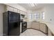 View of the kitchen area, showcasing the appliances, countertops, and windows at 1446 E Grovers Ave # 13, Phoenix, AZ 85022