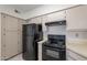 Functional kitchen with full-size appliances, light cabinets, and neutral countertops at 1446 E Grovers Ave # 13, Phoenix, AZ 85022