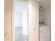 Laundry room with white washing machine, and view into bedroom at 1446 E Grovers Ave # 13, Phoenix, AZ 85022