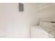 Bright laundry area featuring a washing machine and convenient shelving for storage solutions at 1446 E Grovers Ave # 13, Phoenix, AZ 85022