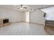 Spacious living room features a cozy fireplace, tile flooring, stairs, and bright natural light at 1446 E Grovers Ave # 13, Phoenix, AZ 85022