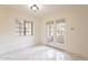 Bright room featuring tile floors, a large window, and access to the exterior at 1446 E Grovers Ave # 13, Phoenix, AZ 85022