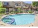 Community pool with a spa, surrounded by manicured landscaping and fencing for privacy at 1446 E Grovers Ave # 13, Phoenix, AZ 85022