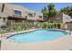 Community pool features a shallow end and mature landscaping, creating a relaxing atmosphere at 1446 E Grovers Ave # 13, Phoenix, AZ 85022
