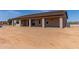 Exterior view showcasing a covered patio and a sizable backyard, creating an outdoor oasis at 20310 W Hubbard Rd, Buckeye, AZ 85326
