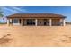 Rear exterior view of a home featuring a covered patio, expansive backyard, and neutral color palette at 20310 W Hubbard Rd, Buckeye, AZ 85326