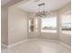 Bright dining room featuring tile floors, neutral walls, and a modern chandelier at 20310 W Hubbard Rd, Buckeye, AZ 85326