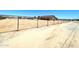 Wide shot of home featuring large fenced yard, mature trees, and neutral exterior paint at 20310 W Hubbard Rd, Buckeye, AZ 85326