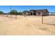 Spacious single story home with large dirt front yard, black metal fencing, and mature landscaping at 20310 W Hubbard Rd, Buckeye, AZ 85326
