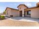 Charming single-story home with neutral stucco exterior, concrete driveway and neat landscaping at 20310 W Hubbard Rd, Buckeye, AZ 85326