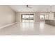Bright, open-concept living room features large sliding glass doors and tile flooring at 20310 W Hubbard Rd, Buckeye, AZ 85326