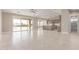 Bright, open-concept living space with a tile floor and connecting kitchen at 20310 W Hubbard Rd, Buckeye, AZ 85326